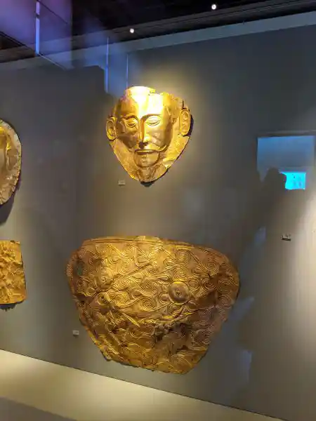 Gold funerary masks, breastplates, and necklace from Grave V, Mycenae
